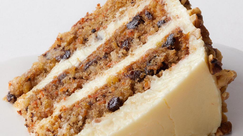 Carrot Cake Slice To Go · The layers of this cake are chock-full with goodness: freshly grated carrot, coconut, pineapple, raisins and walnuts! It is finished with cream cheese icing and toasted walnuts are pressed into the cake’s sides.