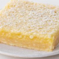 Lemon Bar To Go · Shortbread cookie crust with a tart lemon filling, covered with powdered sugar.