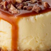 Caramel Pecan Cheesecake To Go · Rich vanilla bean cheesecake topped with caramel and toasted pecans, finished with a graham ...