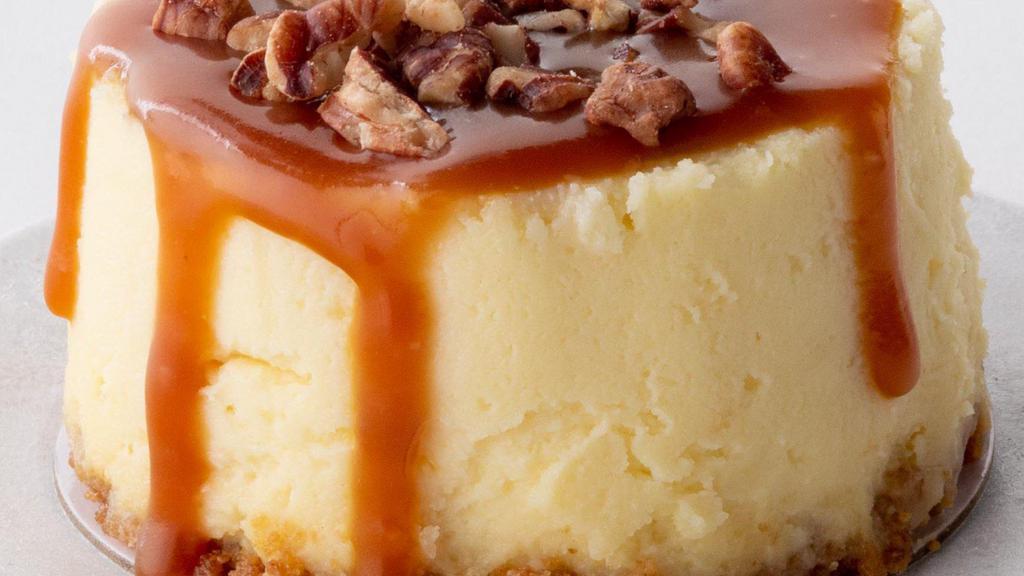 Caramel Pecan Cheesecake To Go · Rich vanilla bean cheesecake topped with caramel and toasted pecans, finished with a graham cracker crust.