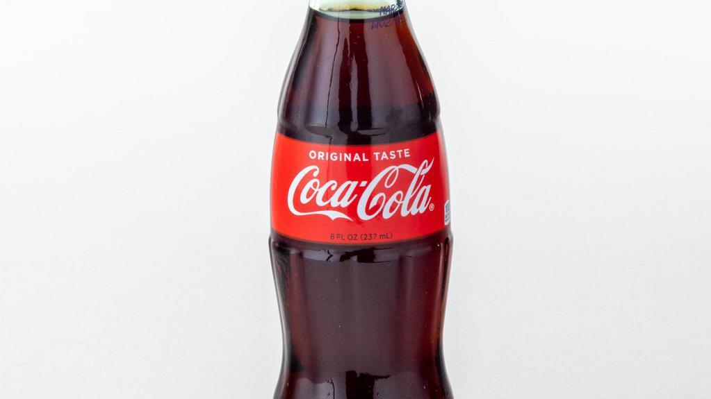 Coke · 8 delicious ounces of Coca Cola in a vintage glass bottle.