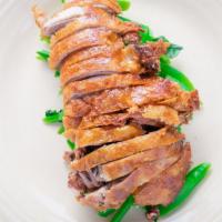 Crispy Duck Over Rice · Roasted crispy boneless half duck with Chinese broccoli, topped with duck soy sauce. Served ...