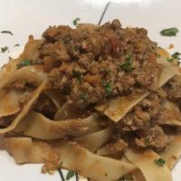 Pappardelle Con Bolognese · Fresh pappardelle in a homemade bolognese sauce.