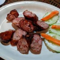 Sai Oua · Grilled pork sausages filled with traditional Laos herbs and spices.