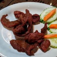 Homemade Jerky (8 Pieces) · Homemade jerky marinated in soy sauce and black pepper seasoning, served with a bed of cucum...