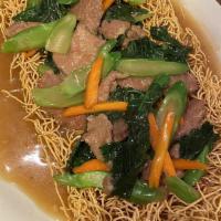 Mee Crob · Crispy deep-fried rice noodles coated and sautéed with Chinese broccoli topped with brown gr...