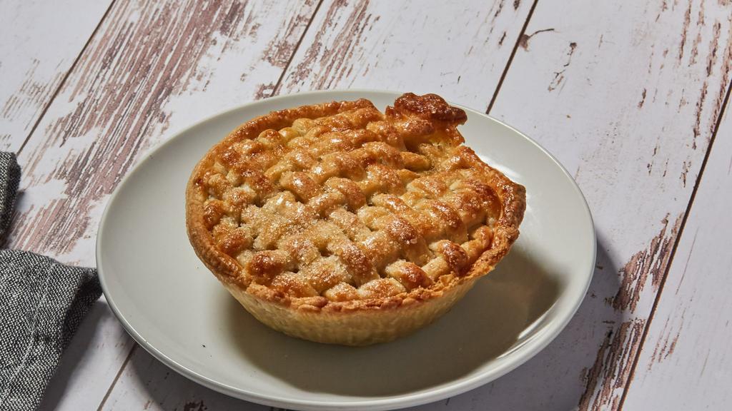 Spiced Apple Pie · Buttery handmade pie crust with a blend of sweet and tart apples with spice blend filling. Finished with a light sprinkle of Turbinado sugar.