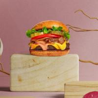Onion And Swiss Burger  · Juicy beef patty with piled with sautéed onions, Swiss cheese, lettuce, and tomato served on...
