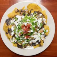 Nachos Regulares · Refried beans, rancho cheese,cotija,sour cream,lettuce, and, Pico de gallo. No meat.