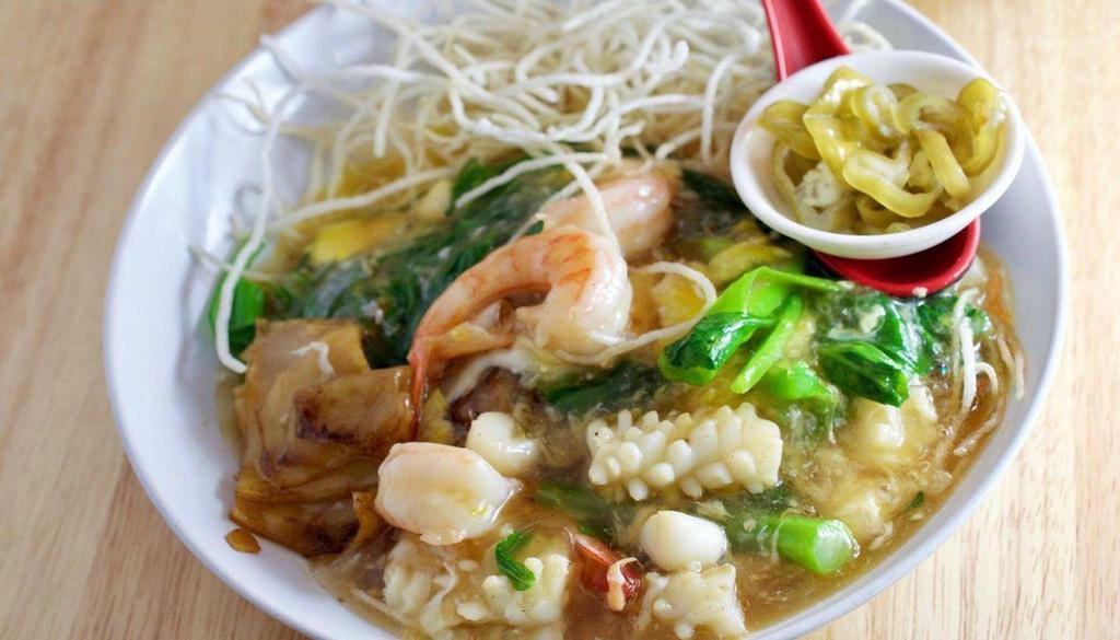 Cantonese Chow Fun 广东滑蛋河米 · Wok-fried broad rice noodles and rice vermicelli, shrimp, calamari, pork, and bok choy in tasty egg gravy.