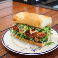 Spicy Yardbird · fried chicken brushed with housemade hot sauce, topped with bread and butter pickles, friseé...