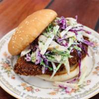 Fish Sando · panko breaded mahimahi, fried and topped with cabbage slaw tossed with asian pear, caper and...