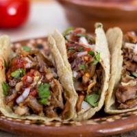 Tacos · Tasty & Delicious 4-inch corn tortilla, topped with birria meat, onion, cilantro, and sauce.