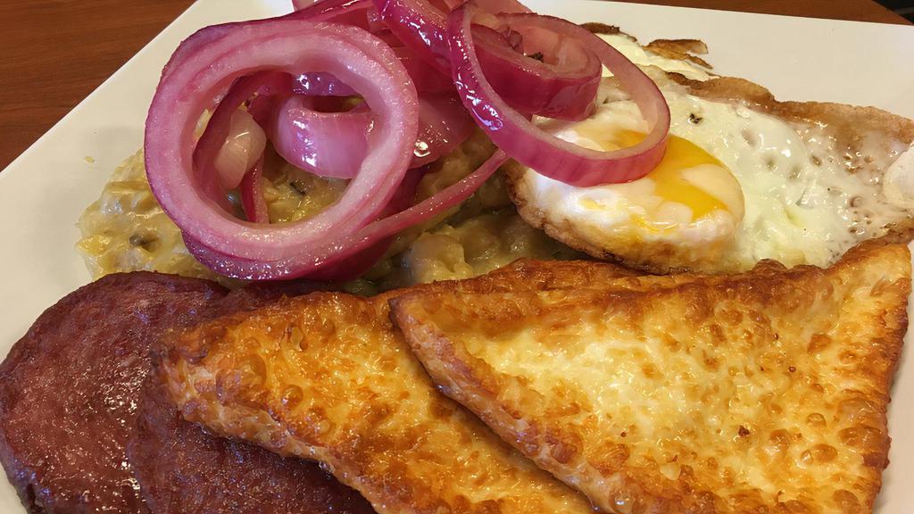 Dominican Tres Golpes · Traditional Dominican Breakfast - Fried Salami, fried eggs, fried cheese, mangú topped with sautéed red onions
