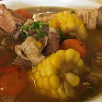 Sancocho Soup · Traditional Dominican stew with oxtail, pork, chicken, cassava, green plantain, corn.  Serve...