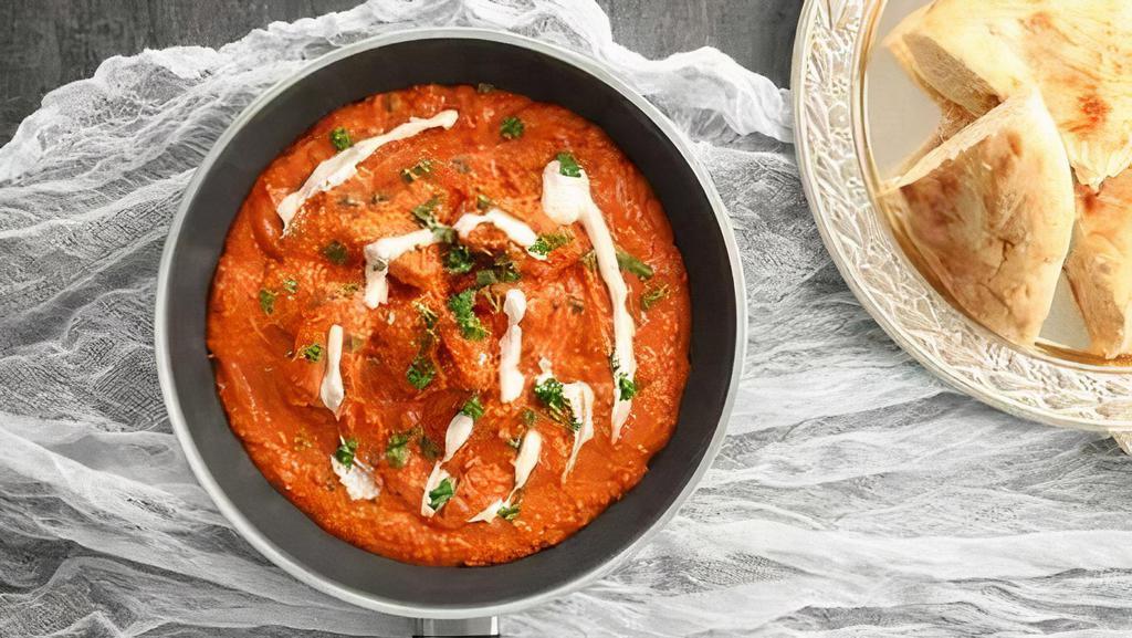 Butter Chicken Mild Spicy With Rice · Chicken gets cooked in tomatoes and butter gravy until the meat is fall off the bone soft served with rice.