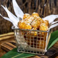Parmesan Truffle Tots · Crispy tater tots with freshly grated parmesan cheese, white truffle oil, and chives.