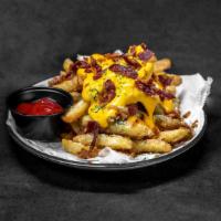 Bacon Cheese Fries · Crispy hand-cut fries with our homemade cheese sauce topped with a crispy bacon crumble.