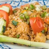 Pineapple Fried Rice · Thai style fried rice with pineapple, raisins, carrots, bell peppers, onions, and cashew nuts.