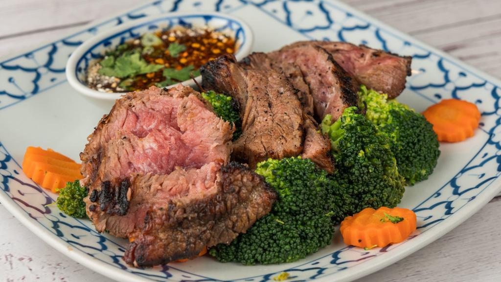 Crying Tiger · Grilled prime-cut marinated tender beef served with spicy lemon juice and steamed vegetables.