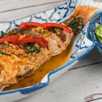 Crispy Whole Fish · With chili-garlic basil sauce. Side of steamed veggies and rice.
