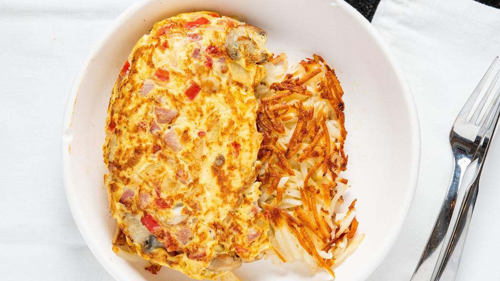 Three Egg Omelette · Hash browns and a choice of four ingredients: ham, bacon, sausage, mushrooms, onions, peppers, tomatoes, spinach, American, swiss or cheddar cheese and a choice of toast. Whole regular eggs or egg whites available.