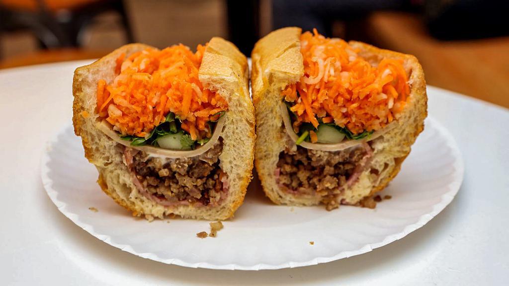 Bánhmi · Vietnamese sandwich. White bread, spread with butter and mayo dressed with cucumber, cilantro, crispy pickled carrot and daikon radish.