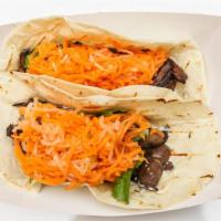 Tacos · Flour tacos. Two soft flour tortillas, spread with butter and mayo dressed with cucumber, ci...