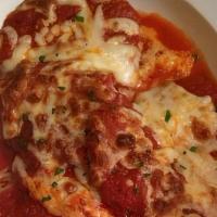 Chicken Parmigiana · Golden fried chicken cutlet served with our homemade tomato sauce and topped with mozzarella...
