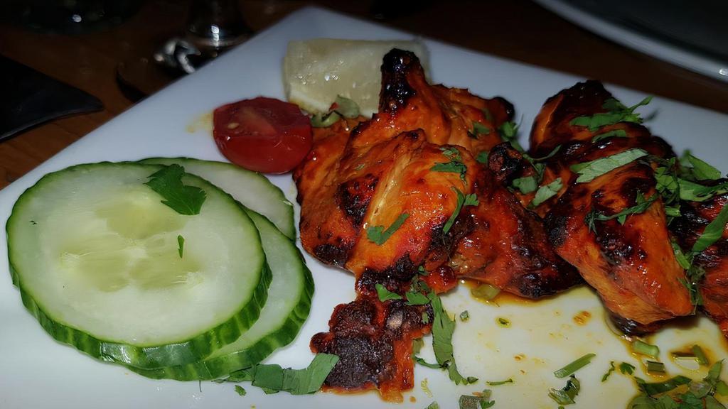 Chicken Tikka · Skewered strips of boneless chicken marinated in herbs, spices, and yogurt. Grilled in clay oven.