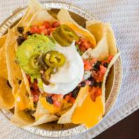 Nachos · Chips with melted Jack and Cheddar cheeses, black beans, jalapeños, sour cream, guacamole an...