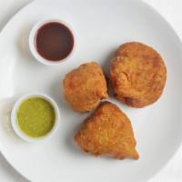Samosa · Savory puff pastries filled with potatoes and peas.