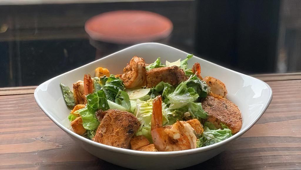 Cajun Shrimp & Salmon Caesar Salad · Grilled Shrimp and Salmon on top of crispy romaine, parmesan, garlic croutons, caesar dressing