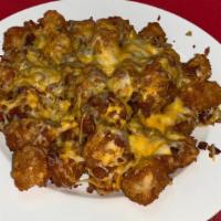Smothered Tater Tots · With bacon & melted cheese, served with chipotle ranch dipping sauce.
