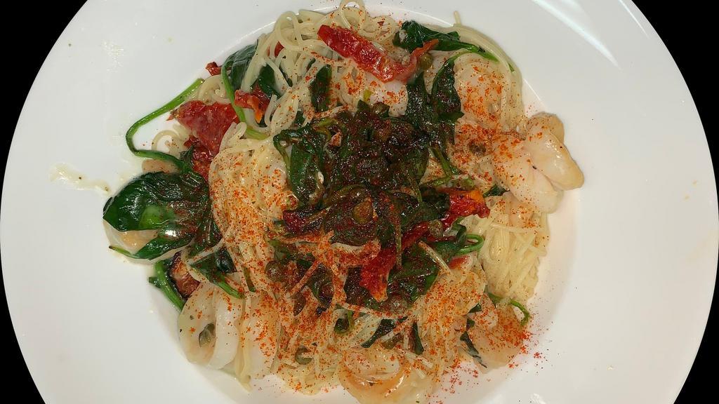 Shrimp Capellini · Sautéed shrimp with spinach, sun-dried tomatoes, in a roasted garlic caper sauce.