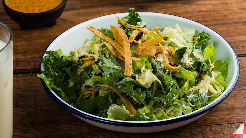 Caesar Salad · Kale and Crispy Romaine Caesar Salad with an old school classic dressing and thinly sliced tortilla strips!