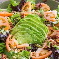 House Salad · Spring Greens, half an avocado, tomatoes, cucumber, mushrooms, and shredded cheese with a si...