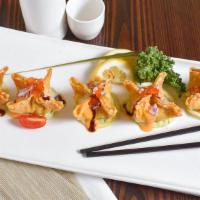 Spicy Tuna Gyoza · Spicy crunchy tuna wrapped with wonton skin and served with homemade guacamole sauce. Hot an...
