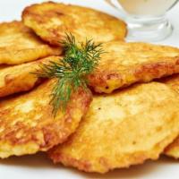 Potato Pancakes · Our fried potato pancakes served with sour cream and applesauce.