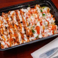 Chicken Over Rice · Halal chicken over rice with salad, white sauce and hot sauce