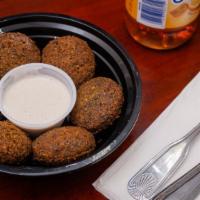 Falafel · Prepared with middle eastern salad mix rolled inside a fresh pita or laffa and dressed with ...