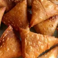 Samosa · Crispy thin sheets of dough wrapped around spiced, minced chicken. Bangladeshi specialty.