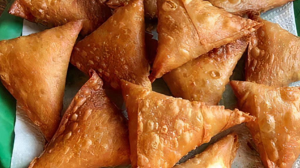 Samosa · Crispy thin sheets of dough wrapped around spiced, minced chicken. Bangladeshi specialty.