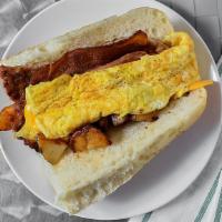 Hungry Man · Ham, bacon, sausage, potatoes, american cheese and scrambled eggs on a hero or wrap. It's  a...
