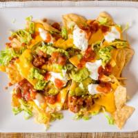 Nachos · Tortilla chips, olives, lettuce, jalapeños, sour cream, guacamole and nacho cheese.