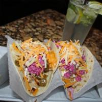 Fish Tacos · Guinness beer battered cod with cilantro aioli, shredded lettuce, red onions, pico de gallo,...