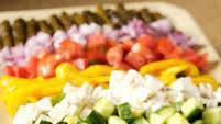 Horiatiki Salad (Greek Salad) (Large) · Greek salad with romaine lettuce, tomatoes, cucumbers, red onions, olives, Dolmadakia and fe...