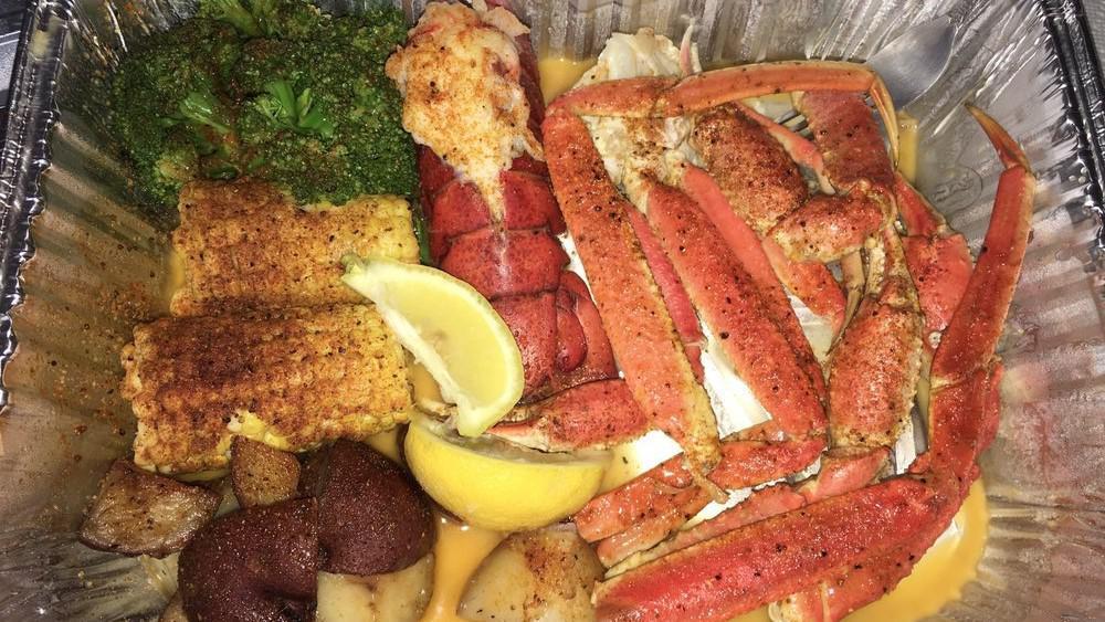 Combo J · 1 cluster of snow crab legs and 1 lobster tail comes with red potatoes, 2 pieces of corn, and broccoli.