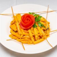 Penne Alla Vodka · Pencil point pasta with a fresh tomato cream sauce, prosciutto, peas and Parmigiano Reggiano...