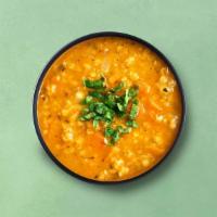 Classic Yellow Lentils · Slow-cooked lentils, tempered with whole and ground spices, onions, tomatoes, and herbs. Ser...